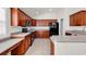 Kitchen features wooden cabinets, stainless appliances, and a view of the tile floor at 2454 N Windmill Way, Myrtle Beach, SC 29579