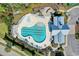 Aerial view of community pool with chairs, landscaping, and clubhouse at 2602 Blue Crane Circle # 104, Myrtle Beach, SC 29577