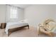 Bright bedroom featuring a wood frame bed, chair, and neutral decor at 2602 Blue Crane Circle # 104, Myrtle Beach, SC 29577