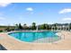 Large community pool surrounded by lounge chairs, umbrellas, and palm trees at 2602 Blue Crane Circle # 104, Myrtle Beach, SC 29577