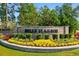 Elegant Belle Harbor brick community sign surrounded by colorful landscaping, lush greenery, and mature trees at 2602 Blue Crane Circle # 104, Myrtle Beach, SC 29577