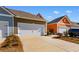 Attached two-car garage with white door and black hardware, complemented by attractive landscaping at 2602 Blue Crane Circle # 104, Myrtle Beach, SC 29577