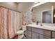 Stylish bathroom featuring a single vanity, mirror, and tub with a decorative curtain at 269 Leste Rd., Myrtle Beach, SC 29588