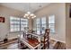 Dining area featuring a chandelier, a wood table with bench seating, and natural light from large windows at 269 Leste Rd., Myrtle Beach, SC 29588