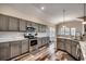 Modern kitchen with stainless steel appliances, gray cabinets, quartz countertop, and hardwood floors at 269 Leste Rd., Myrtle Beach, SC 29588