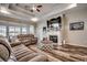 Comfortable living room with a fireplace, hardwood floors, a ceiling fan, recessed lights, and a large TV at 269 Leste Rd., Myrtle Beach, SC 29588