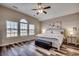 A spacious bedroom featuring a ceiling fan, wood-look flooring, and large windows at 269 Leste Rd., Myrtle Beach, SC 29588