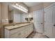 Bright bathroom features double sinks, granite countertops and a large mirror at 2749 Sanctuary Blvd., Conway, SC 29526