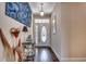 Welcoming front entry hallway with decor, hardwood floors, and an elegant front door at 2749 Sanctuary Blvd., Conway, SC 29526