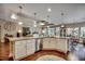 Open kitchen featuring a granite island, white cabinets, and hardwood floors, connecting to the living area at 2749 Sanctuary Blvd., Conway, SC 29526