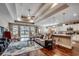 Open-concept living room featuring a tray ceiling, hardwood floors, and seamless flow into the kitchen area at 2749 Sanctuary Blvd., Conway, SC 29526