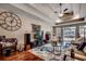 Spacious living room showcasing hardwood floors, a tray ceiling, and comfortable seating arrangements at 2749 Sanctuary Blvd., Conway, SC 29526