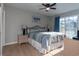 A well-lit bedroom showcasing a queen bed, ceiling fan, and bright natural light at 311 Cumberland Terrace Dr. # 7-E, Myrtle Beach, SC 29572