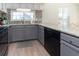 Kitchen area featuring granite countertops, gray cabinets, black appliances, and a tile backsplash at 311 Cumberland Terrace Dr. # 7-E, Myrtle Beach, SC 29572