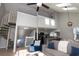 Bright living room featuring a spiral staircase, skylights, and an open floor plan into the kitchen at 311 Cumberland Terrace Dr. # 7-E, Myrtle Beach, SC 29572