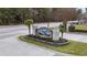 Stone sign marking the entrance to Silver Creek, framed by manicured landscaping and palm trees at 313 Foxpath Loop, Myrtle Beach, SC 29588