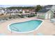 Community pool with clear water, surrounding lounge chairs, and pool house in the background at 313 Foxpath Loop, Myrtle Beach, SC 29588