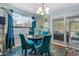 Bright dining area with seating for four, decorative curtains, and access to a screened porch at 313 Foxpath Loop, Myrtle Beach, SC 29588