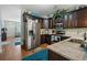 Modern kitchen with stainless steel appliances, granite countertops, and dark wood cabinets at 313 Foxpath Loop, Myrtle Beach, SC 29588