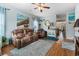 Comfortable living room with hardwood floors, reclining leather furniture, and beach-themed decor at 313 Foxpath Loop, Myrtle Beach, SC 29588