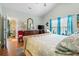 Bright main bedroom with vaulted ceiling features a king bed, dresser, TV, and ensuite bathroom at 313 Foxpath Loop, Myrtle Beach, SC 29588