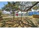 Backyard with mature trees, swing, and access to the water at 315 Oak Dr. N, Surfside Beach, SC 29575