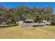 Large backyard with mature trees, fence, and partial view of the home at 315 Oak Dr. N, Surfside Beach, SC 29575