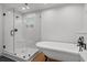 Modern bathroom featuring a frameless glass shower, a soaking tub and black fixtures at 315 Oak Dr. N, Surfside Beach, SC 29575