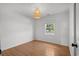 Bedroom featuring hardwood floors, ship lap accent wall, and a modern woven light fixture at 315 Oak Dr. N, Surfside Beach, SC 29575