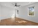 Bright bedroom with hardwood floors, shiplap accent wall, modern ceiling fan, and natural light from two windows at 315 Oak Dr. N, Surfside Beach, SC 29575