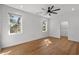 Bright bedroom with hardwood floors, shiplap accent wall, modern ceiling fan, and a closet at 315 Oak Dr. N, Surfside Beach, SC 29575