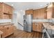 Modern kitchen with wood cabinets, stainless steel refrigerator, and granite counters at 315 Oak Dr. N, Surfside Beach, SC 29575