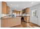 Spacious kitchen with wood cabinets, granite counters, and stainless steel appliances at 315 Oak Dr. N, Surfside Beach, SC 29575