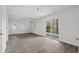 Bright living room with wood-look flooring, beadboard, and sliding door to deck at 315 Oak Dr. N, Surfside Beach, SC 29575