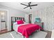 Bedroom featuring hardwood floors, stylish wallpaper, and an ensuite bathroom at 3727 Otter St., Myrtle Beach, SC 29577