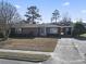 Well-kept home featuring a paved driveway, carport, and manicured lawn in a friendly neighborhood at 3727 Otter St., Myrtle Beach, SC 29577