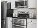 Close up of kitchen range with stainless steel appliances, and white cabinets at 3727 Otter St., Myrtle Beach, SC 29577