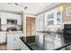 Well-lit kitchen features white cabinets, stainless steel appliances, and black countertops at 3727 Otter St., Myrtle Beach, SC 29577