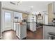 Open-concept kitchen and dining area with white cabinets, stainless steel appliances, and hardwood floors at 3727 Otter St., Myrtle Beach, SC 29577