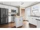 Bright kitchen with white cabinets, stainless steel appliances, hardwood floors, and a center island at 3727 Otter St., Myrtle Beach, SC 29577