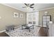 Living room with hardwood floors, rug, ceiling fan, and natural light from a large window at 3727 Otter St., Myrtle Beach, SC 29577