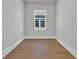 This bedroom features light hardwood floors, grey walls, and a window for natural light at 373 St. Julian Ln., Myrtle Beach, SC 29579