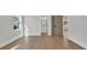 This primary bedroom features an ensuite bathroom, light hardwood floors, and natural light from the window at 373 St. Julian Ln., Myrtle Beach, SC 29579