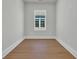 Empty room with hardwood floors and one window, ready for your personal touch at 373 St. Julian Ln., Myrtle Beach, SC 29579