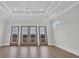 Spacious bedroom with access to a balcony through glass doors and a trey ceiling at 373 St. Julian Ln., Myrtle Beach, SC 29579