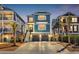 Charming coastal home boasts a two-car garage, welcoming stairway, and vibrant blue exterior with white shutters at 373 St. Julian Ln., Myrtle Beach, SC 29579
