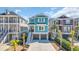 Attractive two-story house showcases a two-car garage, inviting stairway, and vibrant blue exterior with white shutters at 373 St. Julian Ln., Myrtle Beach, SC 29579
