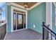 Elegant front porch and entryway featuring a black front door, wood-plank ceiling, and stylish light fixture at 373 St. Julian Ln., Myrtle Beach, SC 29579