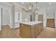 Well-appointed kitchen boasts an island with seating, stainless steel appliances, and stylish pendant lighting at 373 St. Julian Ln., Myrtle Beach, SC 29579