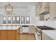 The open kitchen layout features white countertops, custom cabinetry, and stainless steel appliances perfect for any chef at 373 St. Julian Ln., Myrtle Beach, SC 29579